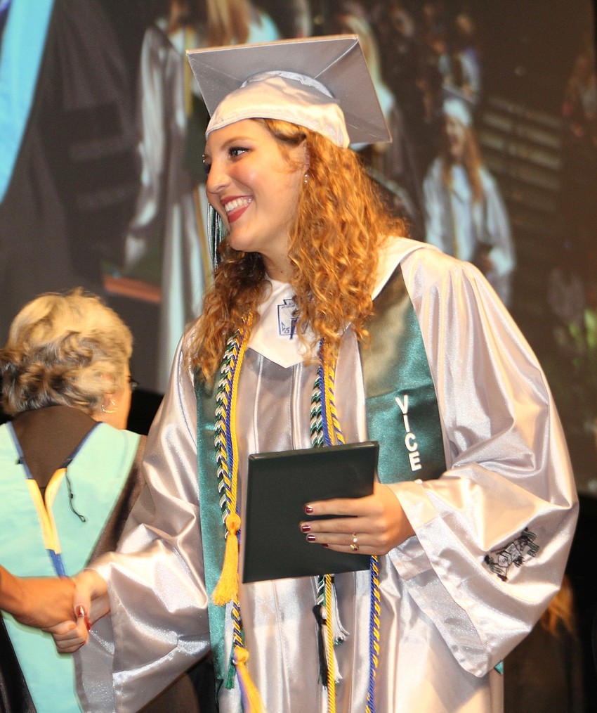 Lakewood Ranch High School graduate Savannah Carpenter is thrilled as she receives her high school diploma.