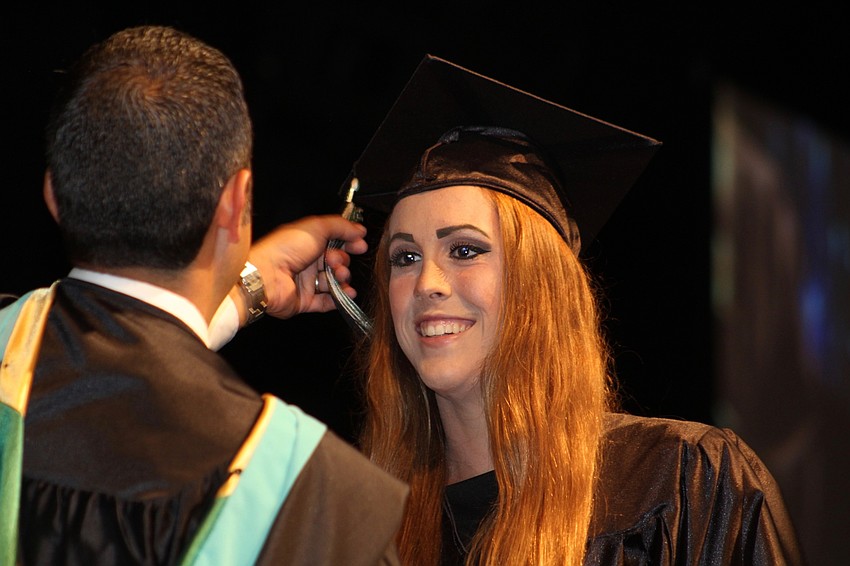 Lakewood Ranch High School graduate Courtney Chapin smiles as Principal Craig Little moves her tassel.