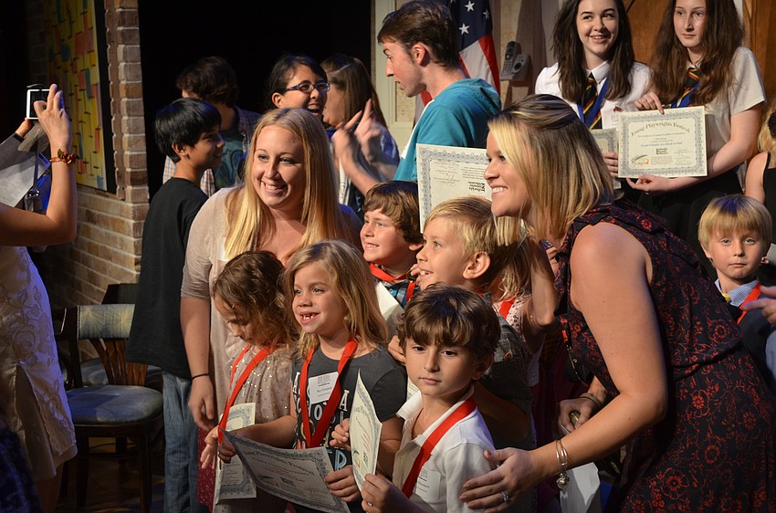 Winning playwrights pose for photos with family members.