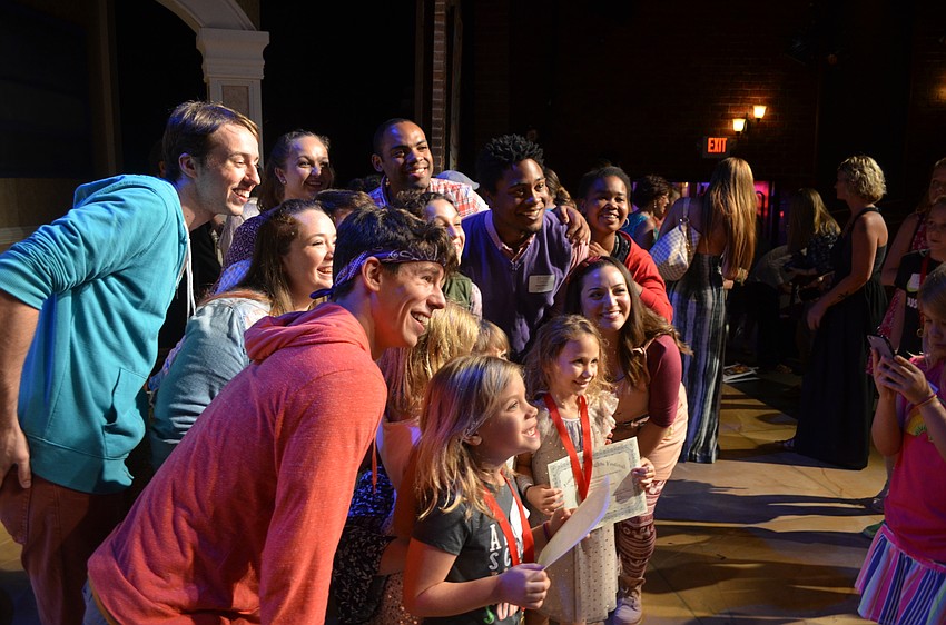 Winning playwrights pose for photos with staff and family members.