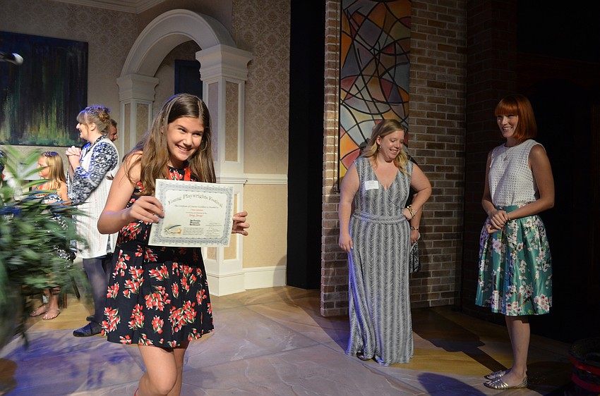 Chloe Johnson shows off her award for her play “Drip, Drop!”