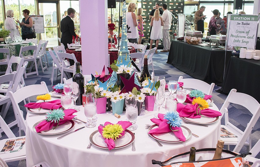 Table 13 guests put a little joie de vivre into their Parisian-themed decor for their table at Men Who Cook & Brew on May 21 at Mattison’s Bayside at Van Wezel Performing Arts Hall.