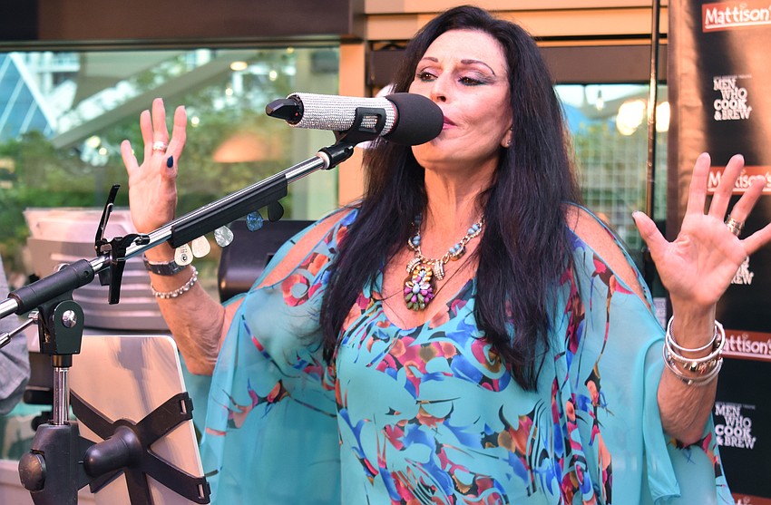 Sheri Nadelman of cover band soulRcoaster performs with her bandmates at Men Who Cook & Brew on May 21 at Mattison’s Bayside at Van Wezel Performing Arts Hall.