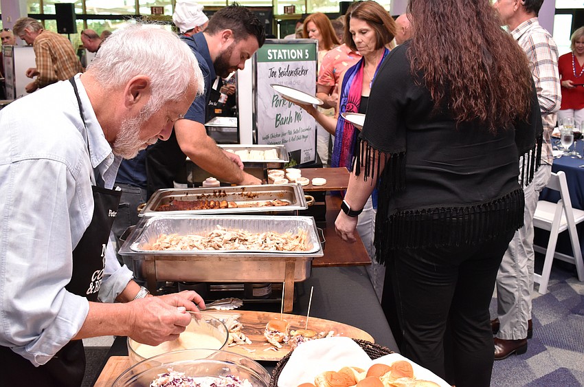 Chefs Peter Amster and Joe Seidensticker prepare food for guests at Men Who Cook & Brew on May 21 at Mattison’s Bayside at Van Wezel Performing Arts Hall.