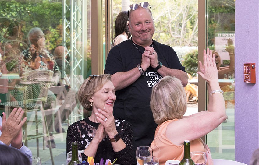 Chef Terry McKee shows his appreciation for his supporters during his grand entrance at Men Who Cook & Brew on May 21 at Mattison’s Bayside at Van Wezel Performing Arts Hall.