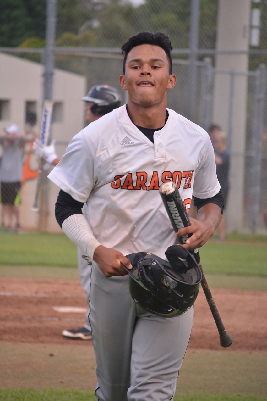 Alex Arauz jogs back to the dugout after scoring the Sailors'     first run.