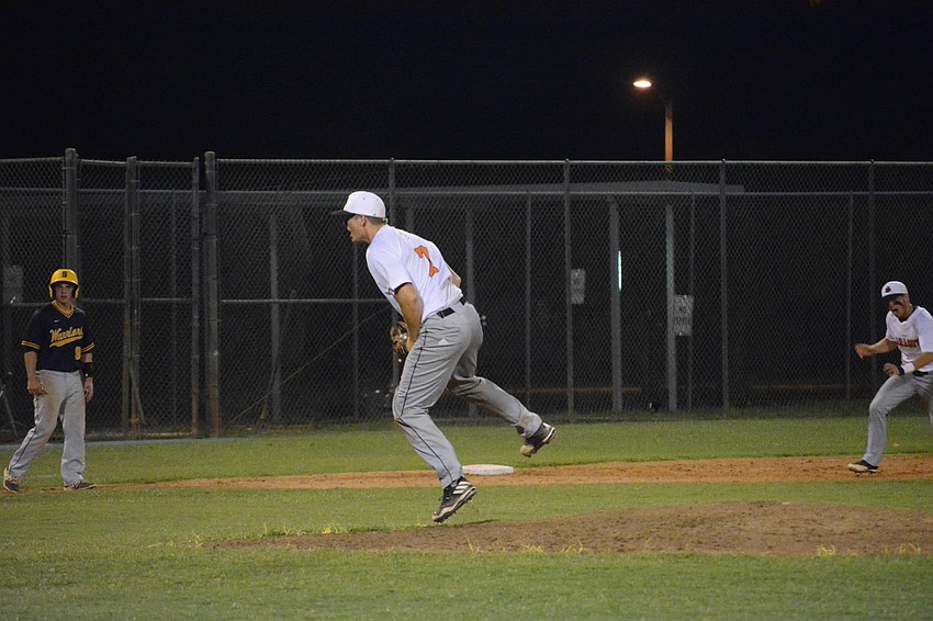 Cole Madden hops off the mound after striking out a Steinbrenner batter to end the game.