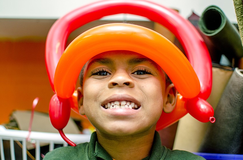 King smiles while showing off his balloon crown. Boys and Girls club participants enjoyed balloons, face paint and presentations by Mote Marine Aquarium and Sarasota County Fire Department after the ribbon cutting.