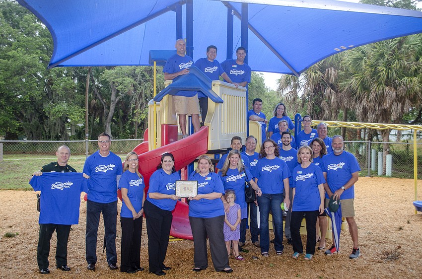 Leadership Sarasota County members pose under the sunshade they constructed for the Roy McBean Boys and Girls club.