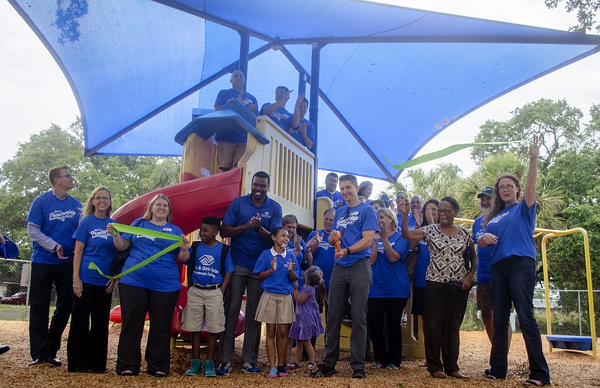 Leadership Sarasota and Boys and Girls Club members cut the ribbon on Project Play and Learn, which included a new sun shade for the play ground, new picnic tables and new benches.