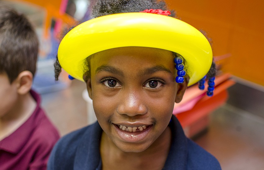 Gizaria shows off her balloon hat. Boys and Girls club participants enjoyed balloons, face paint and presentations by Mote Marine Aquarium and Sarasota County Fire Department after the ribbon cutting.