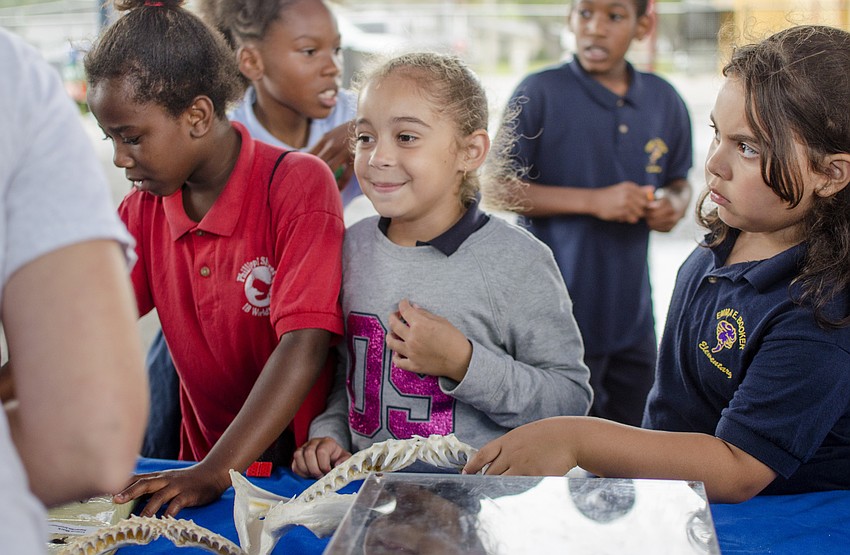 Boys and Girls club participants enjoy a presentation by Mote after the ribbon cutting.