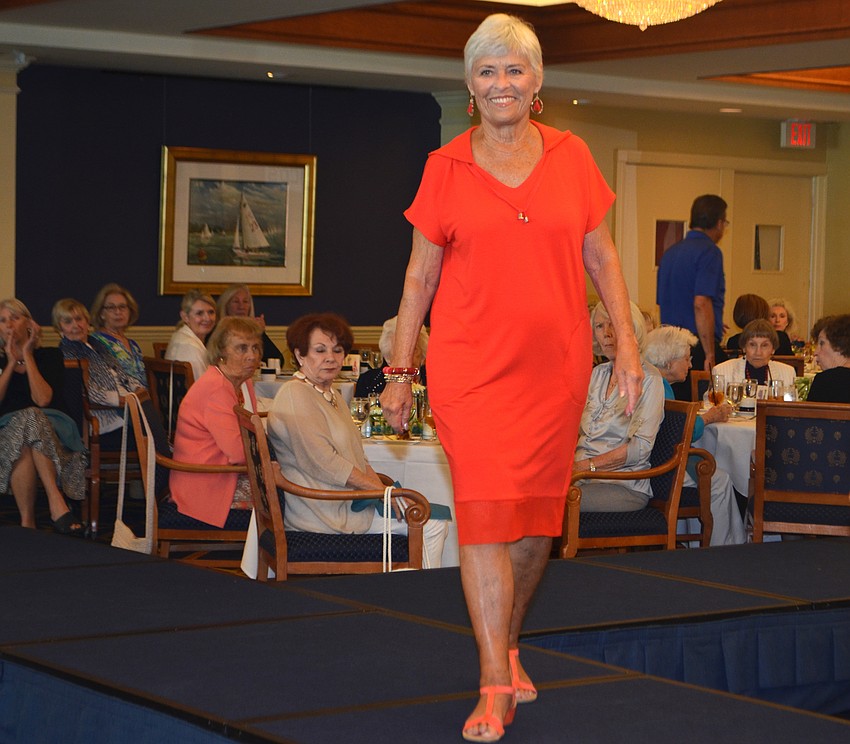 Judy Reed models a sporty red dress described as a perfect outfit for the farmer’s market or seaside lunch.
