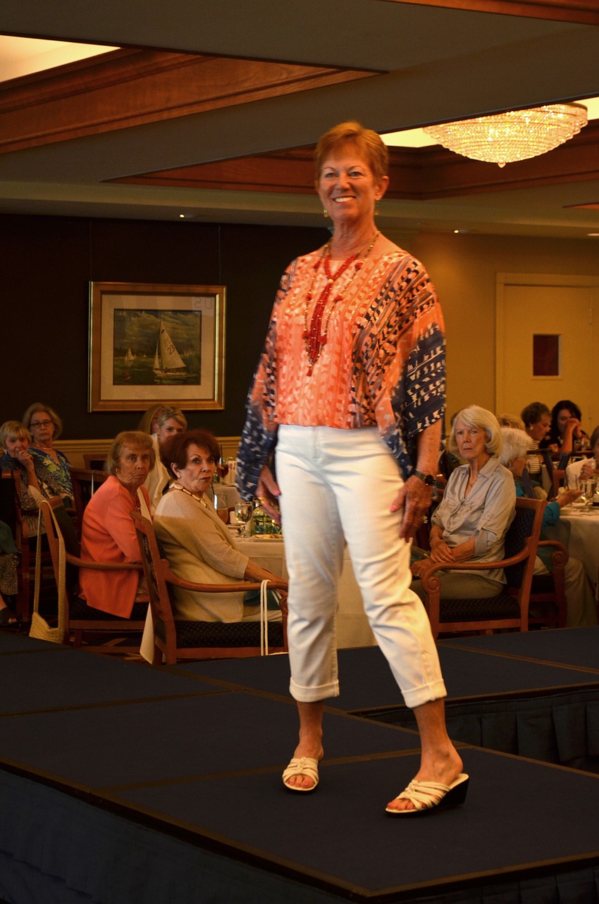 Carol Patulo smiles as she strikes a pose at the end of the runway.
