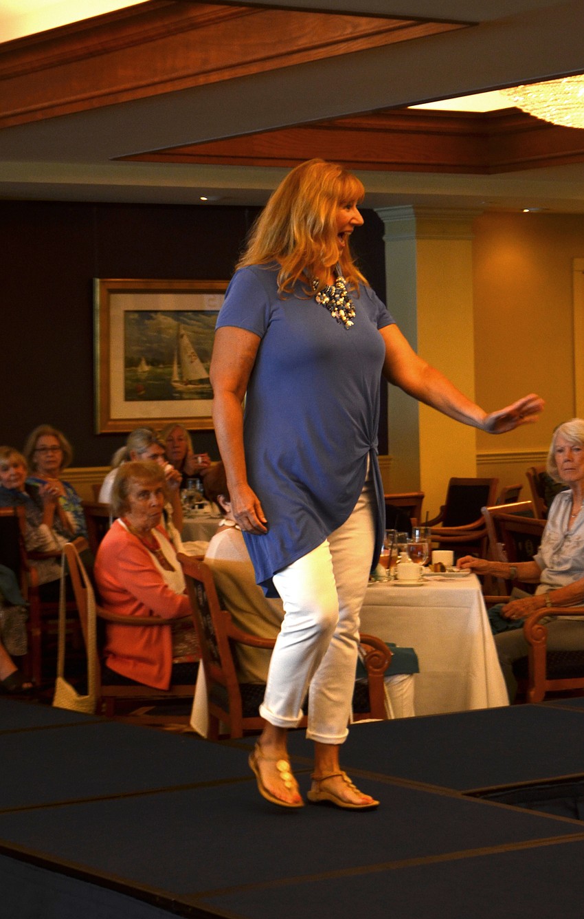Susan Pinzino waves to her friends as she walks the runway.