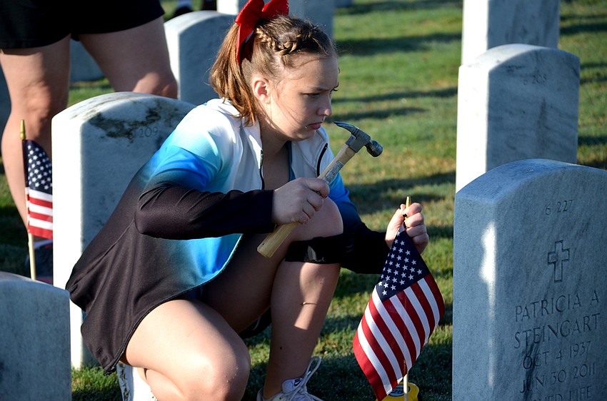 Evelyn Bachman and fellow Lakewood Ranch Gymnastics team members were just some of about 450 volunteers who placed flags at each gravesite before the ceremony.