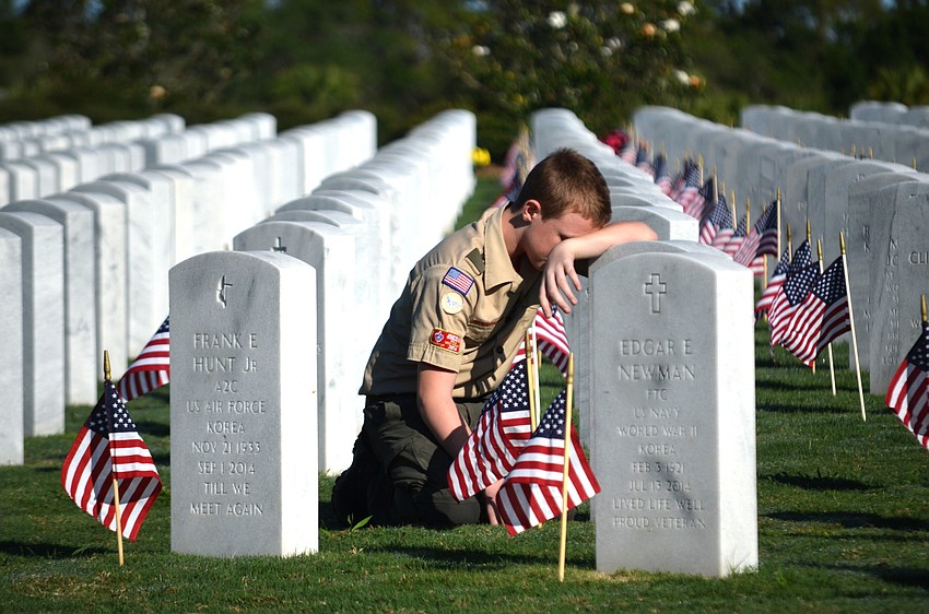 James Thompson takes a moment at his grandfather’s gravesite.