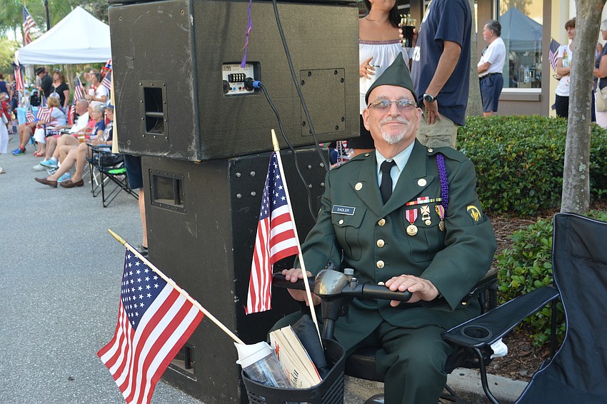Palmetto Army veteran Larry Sadler finds a spot behind the speakers along Lakewood Main Street.