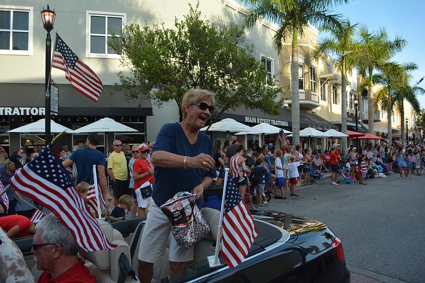County Commissioner Vanessa Baugh throws out a steady stream of candy for the kids.