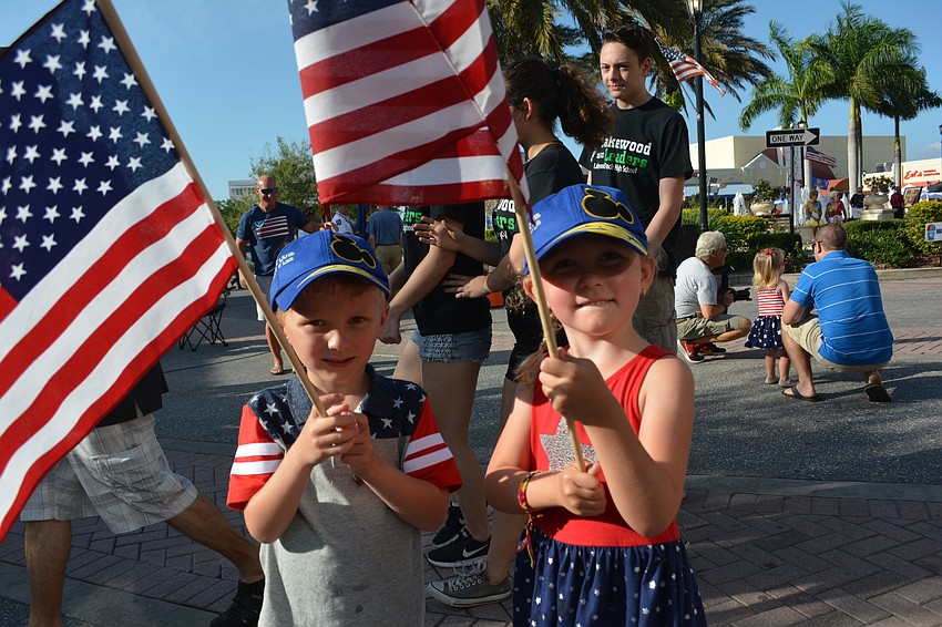 Zander and Zella Zander, both 4, present the colors at the Tribute to Heroes Parade.