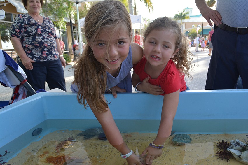 Juliana and Ella Fuschetto check out some sea creatures before the Tribute to Heroes Parade.