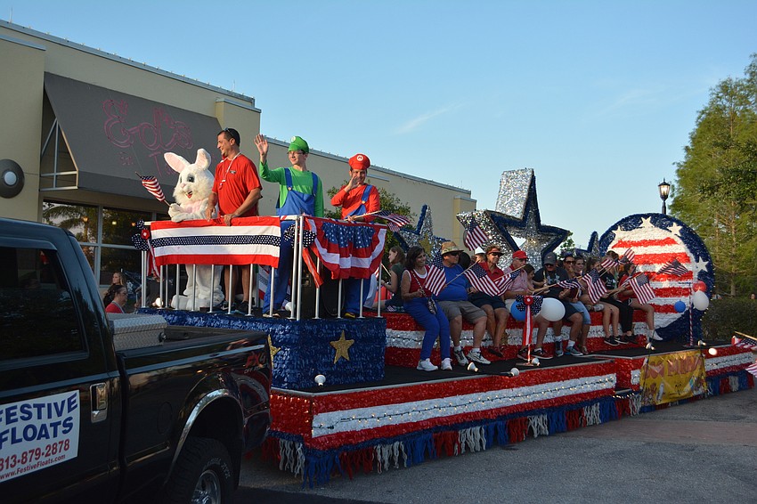 Parade director Keith Pandeloglou rides with the Lakewood Ranch Community Activities float.