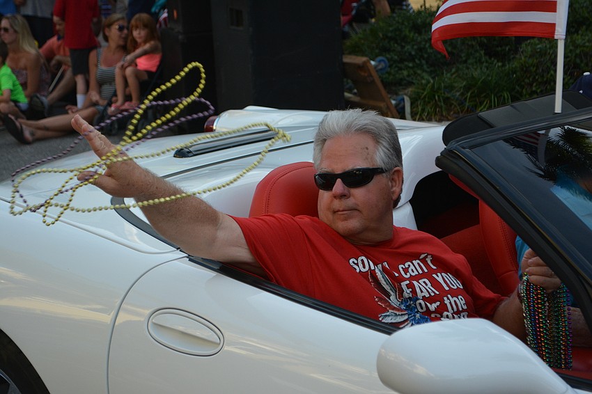 Navy veteran David Sharp shows he knows how to throw beads to the kids.