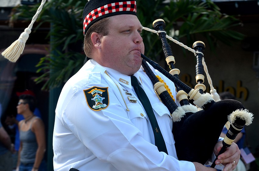 Deputy W. Sell of the Sarasota Sheriff’s Office plays the bagpipes during the parade.