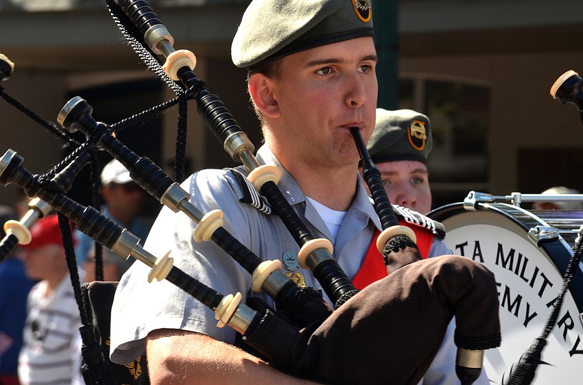 The Sarasota Military Academy Pipe Band plays as they march down Main Street.
