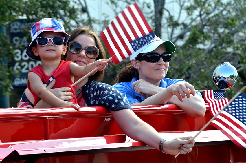 Members of the Kiwanis Club of Sarasota wave to the crowd.
