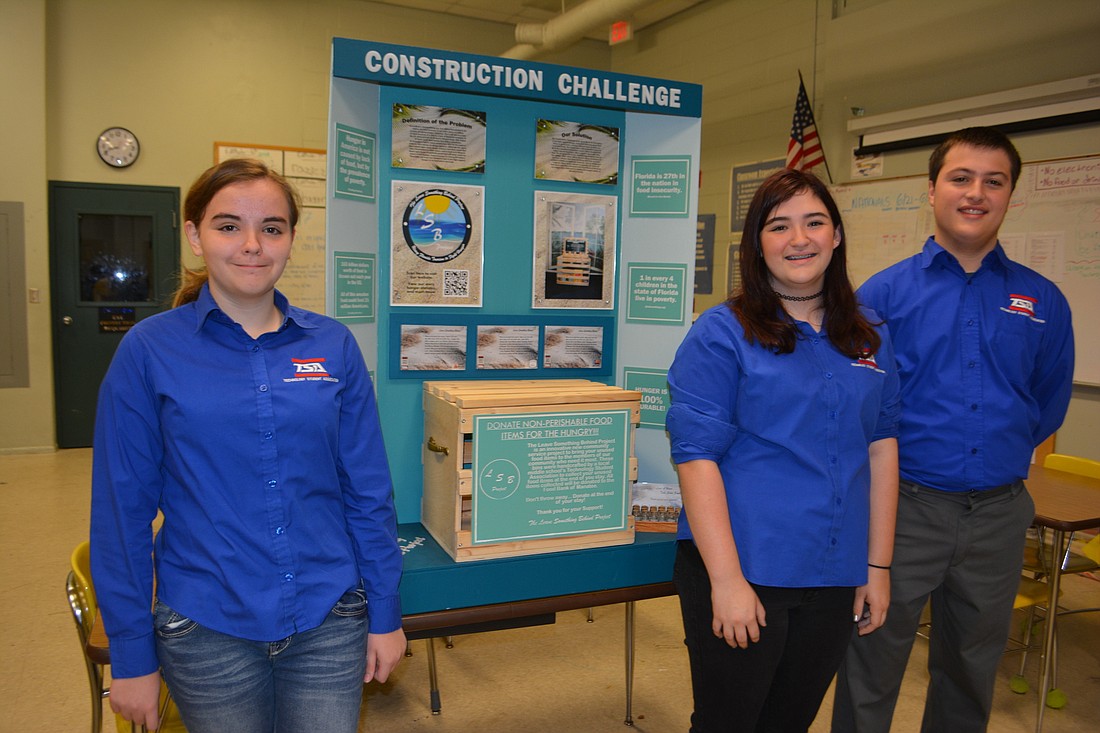 Braden River Middle seventh-grader Sofia Figueras, and eighth-graders Izzy Rines andÂ Sean Davis stand next to their Construction Challenge project.