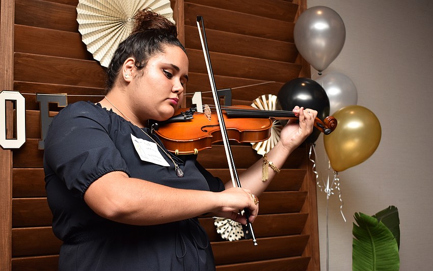 Booker High School student Sheila Uria plays the violin before the program begins at Celebration of Hope on May 31 at The Francis.