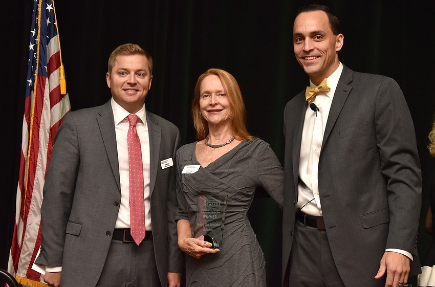 Andy Guz, JoAnne DeVries, president of Health Care & Wellness Organization of the Year Hearing Loss Association of Sarasota, and Greater Sarasota Chamber of Commerce President and CEO Kevin Cooper