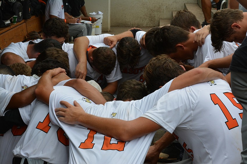 The Sailors pray in a circle pregame.