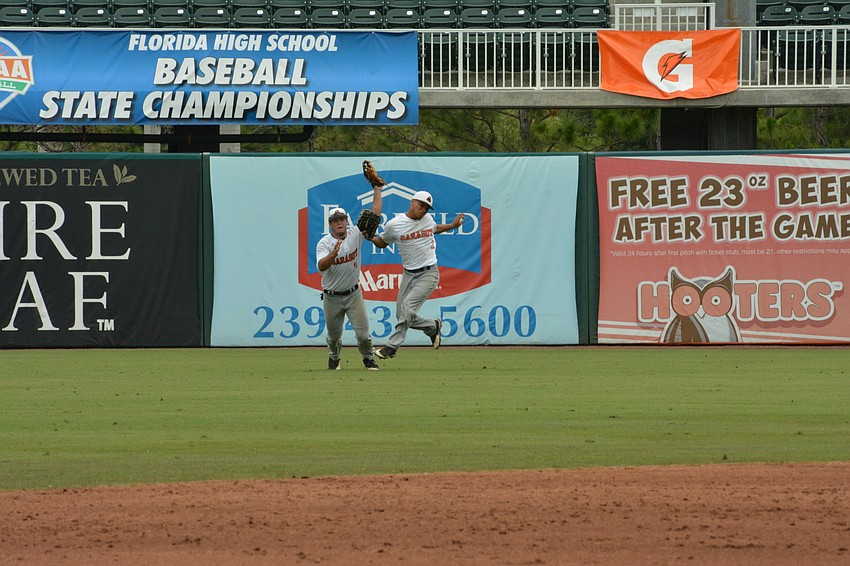 Joey Arnold and Daniel Marin nearly collide in the outfield going for a ball.