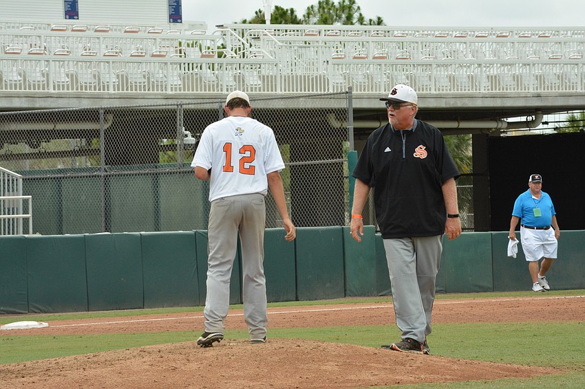 Phil Shore (12) gets warm as Clyde Metcalf watches.