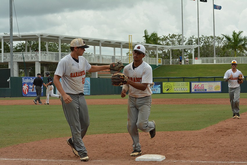 Brooks Larson gives Alex Arauz recognition after an inning.