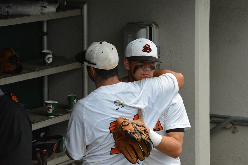 Joey Arnold and Josh Paige embrace after the game.