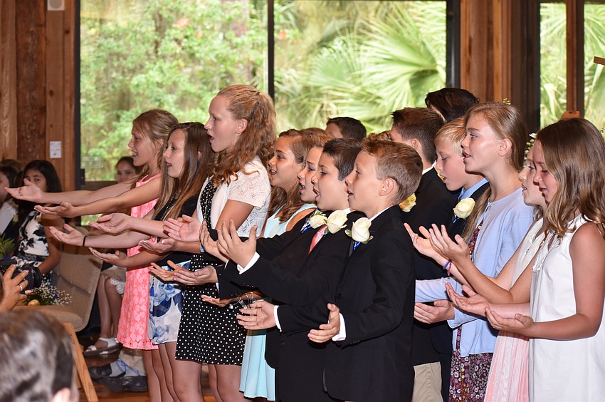 Graduating fifth graders sing “The World is Ours” at the Out-of-Door Academy Lower School Graduation on June 2 at Siesta Key Chapel.