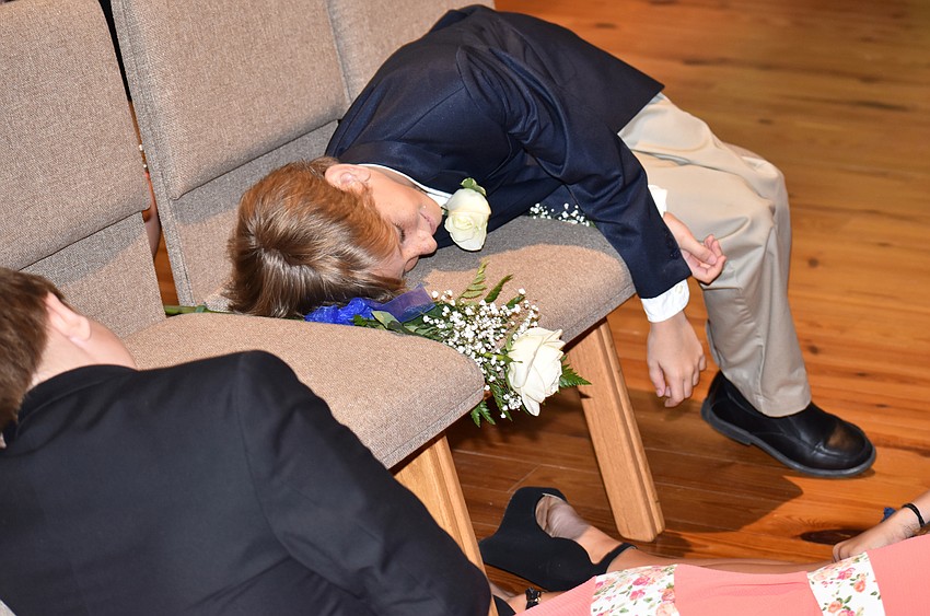 Graduating fifth graders pretend to be lifeless dolls — part of the Toy Story Challenge — after hitting the floor when Head of Lower School Tanna Horner shouted “Andy’s coming!” at the Out-of-Door Academy Lower School Graduation.