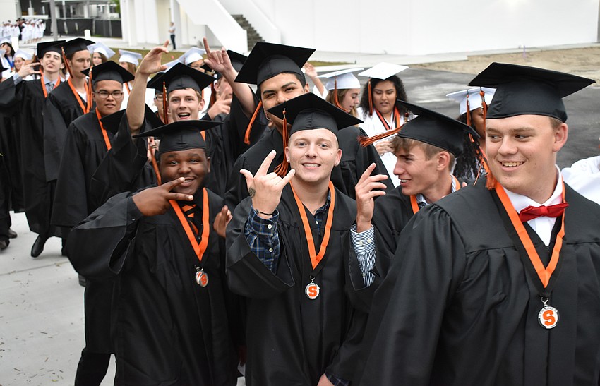 Graduates goof off in line outside the stadium before graduation on June 2 at Sarasota High School.