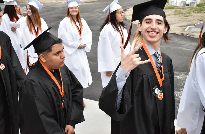 Graduates goof off in line outside the stadium before graduation on June 2 at Sarasota High School.