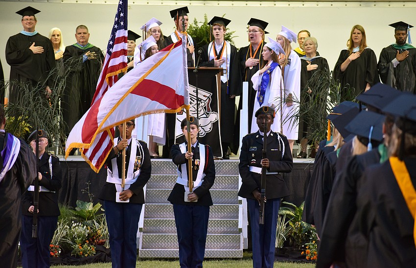 The crowd sings the National Anthem during Sarasota High School graduation at Cleland Stadium at Ihrig Field.