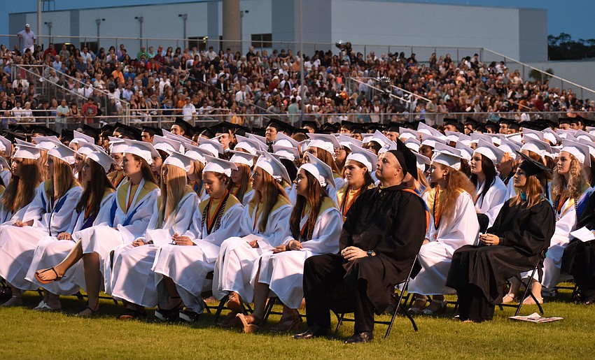 Students and faculty listen to student speeches during Sarasota High School graduation at Cleland Stadium at Ihrig Field.