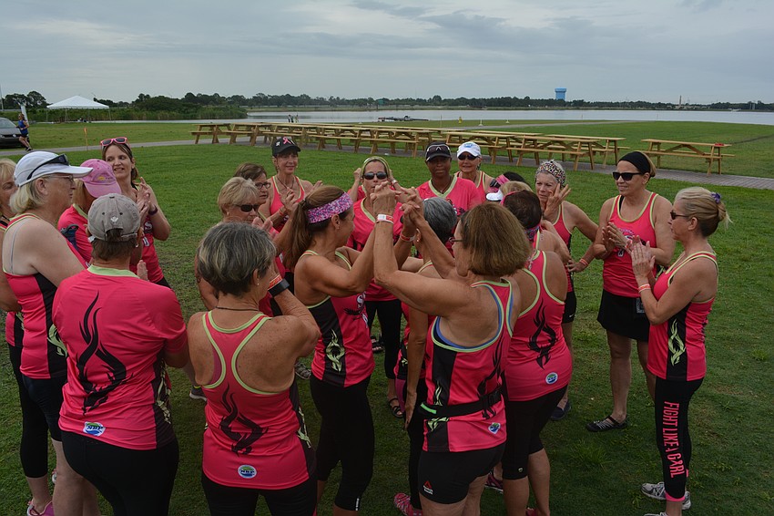 Survivors in Sync team members get their competitive juices flowing with a huddle before the race.