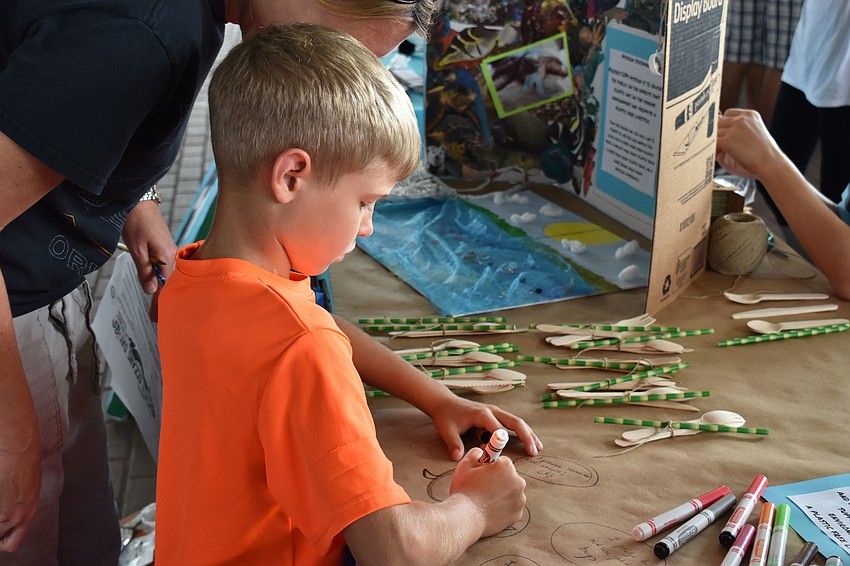 Dylan Hardesty pledges to keep the ocean clean at World Oceans Day on June 3 at Mote Aquarium.