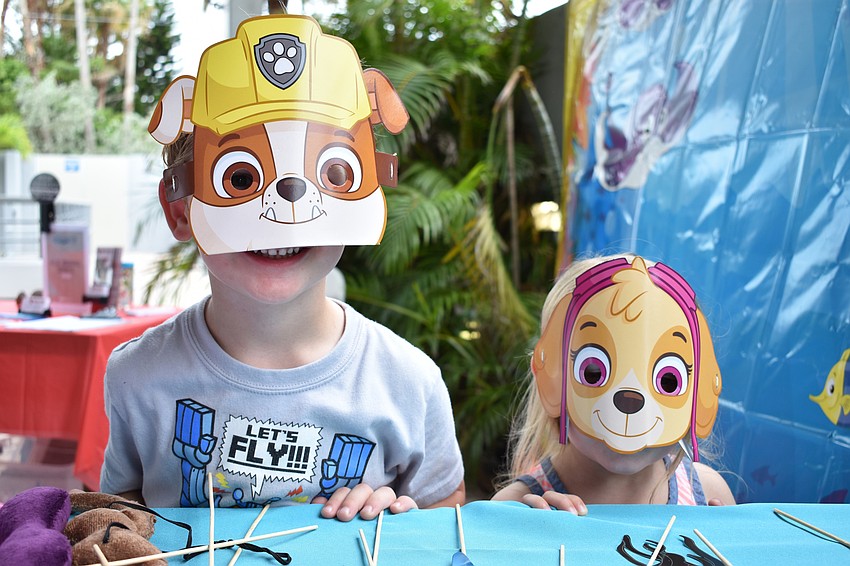 Trenton Layport and Audrey Hirst show off their masks at the costume table at World Oceans Day on June 3 at Mote Aquarium.