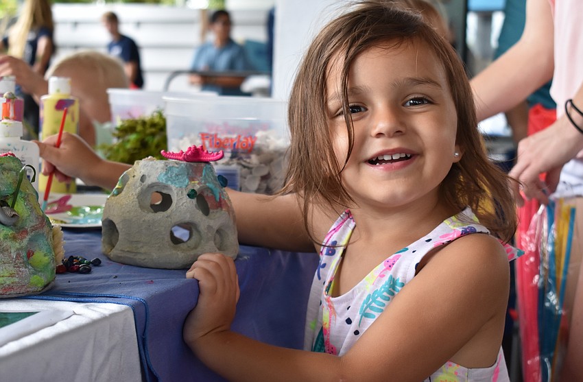 Kierra Hutson paints a ceramic aquarium decoration at World Oceans Day on June 3 at Mote Aquarium.