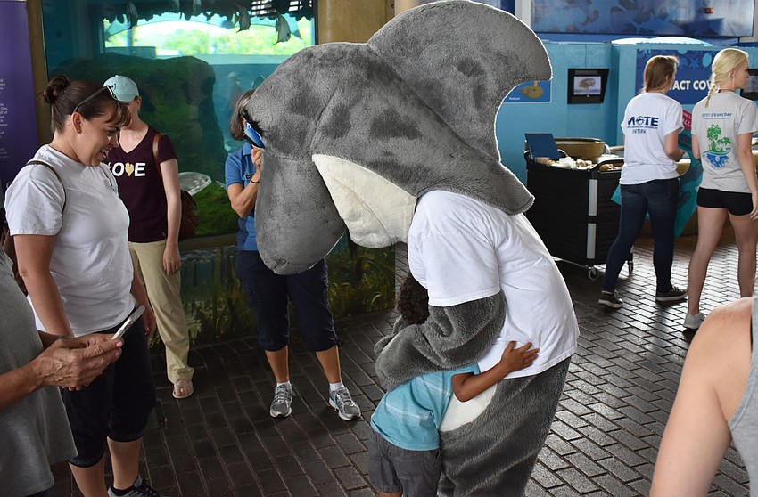 Benjamin Livingston hugs Gilly at World Oceans Day on June 3 at Mote Aquarium.