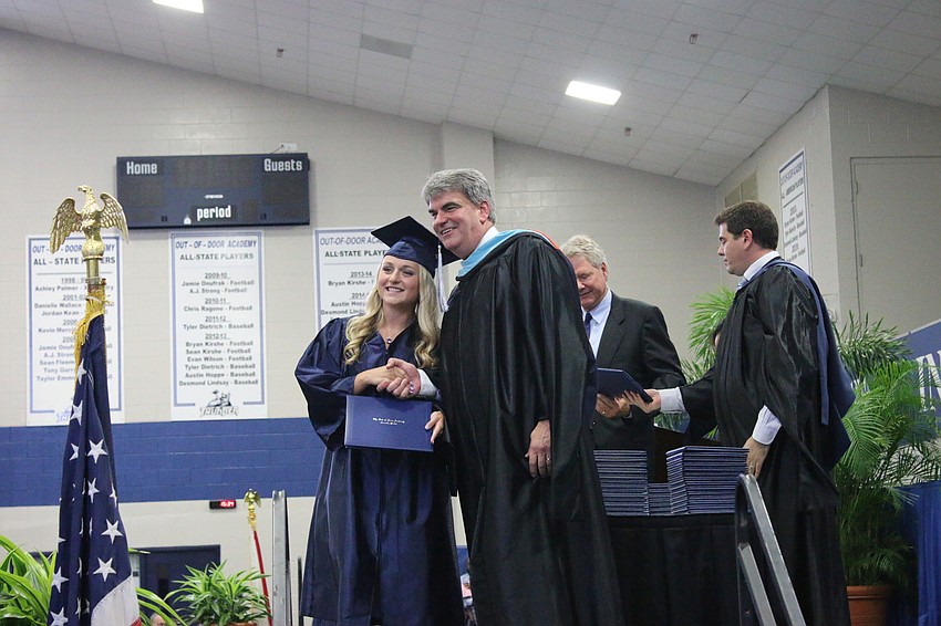 Greta Holland accepts her diploma from Head of School David Mahler. Courtesy photo.